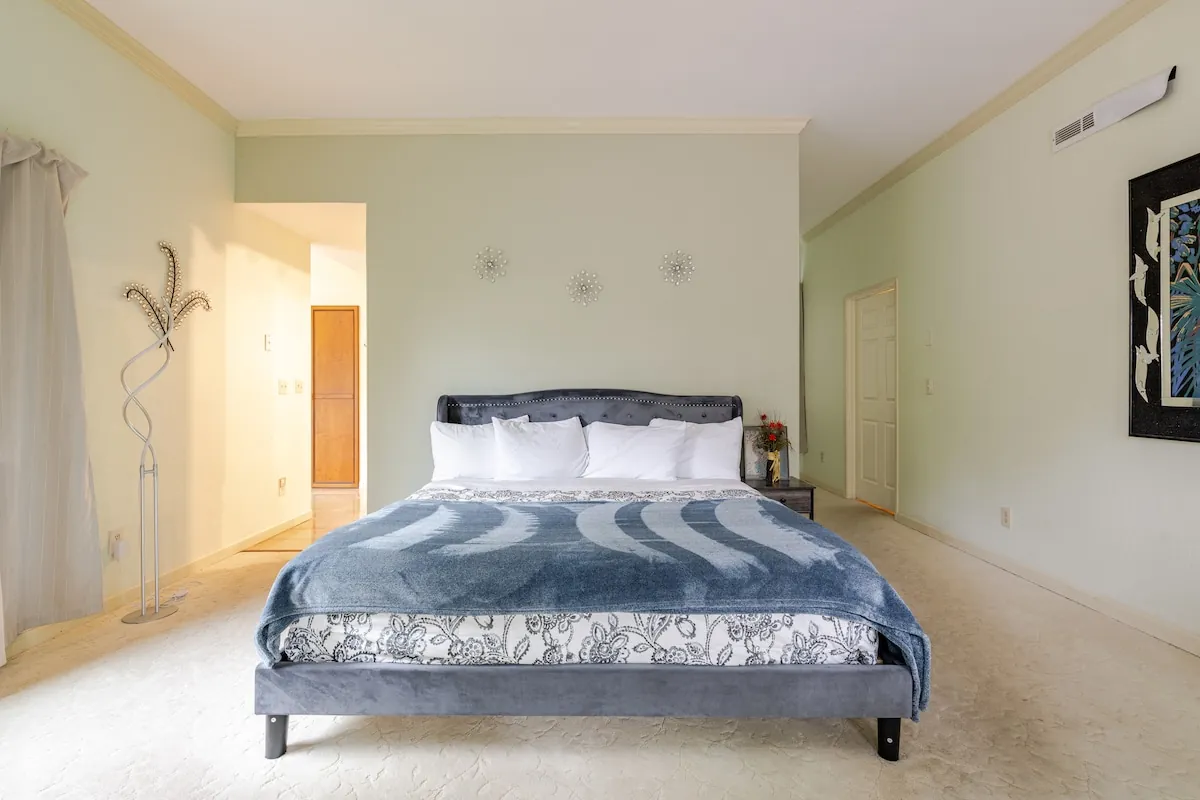 Primary bedroom with king bed and wall art
